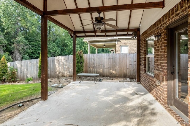 view of patio / terrace with ceiling fan and fence