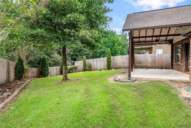 view of yard with a patio area, a fenced backyard, and a ceiling fan