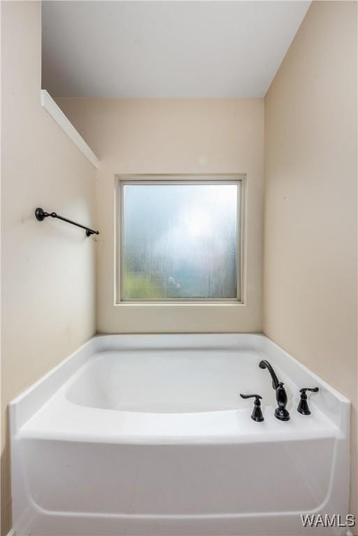 full bath featuring plenty of natural light and a bath