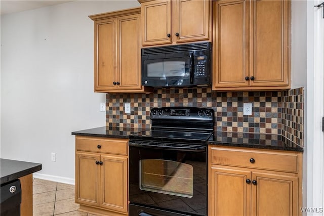 kitchen with baseboards, decorative backsplash, brown cabinets, black appliances, and light tile patterned flooring