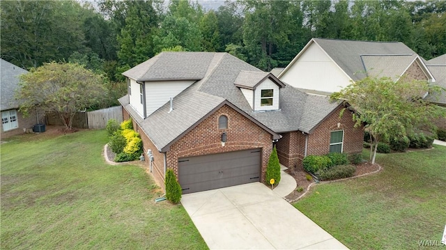 view of front facade featuring concrete driveway, brick siding, fence, and a front lawn