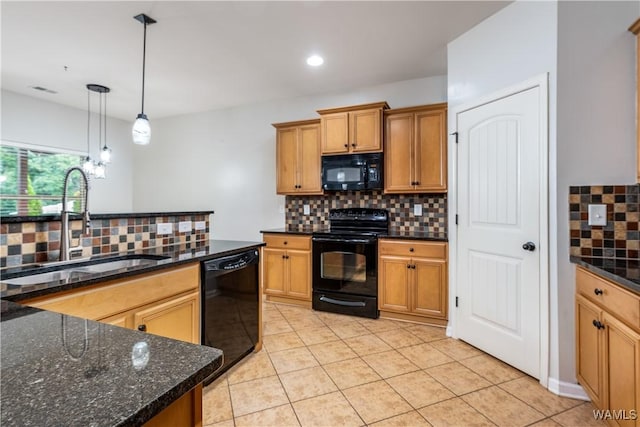 kitchen with light tile patterned floors, black appliances, a sink, and pendant lighting