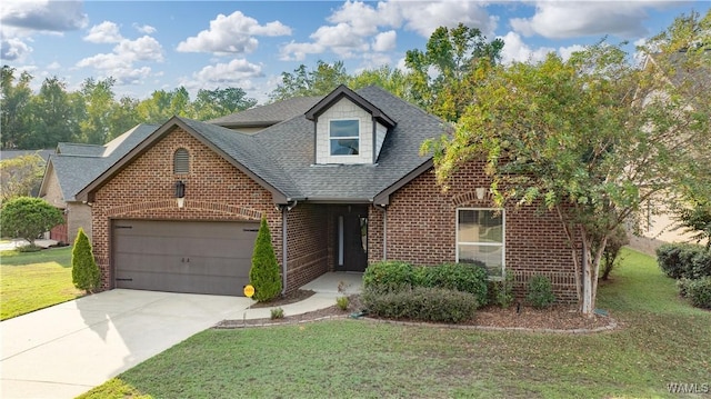 view of front of house with a front yard, concrete driveway, brick siding, and an attached garage