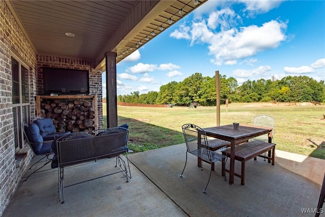 view of patio with exterior fireplace