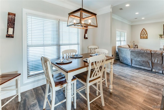 dining room featuring ornamental molding and dark wood-type flooring