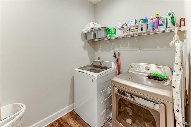 laundry room with dark wood-type flooring and washer and dryer