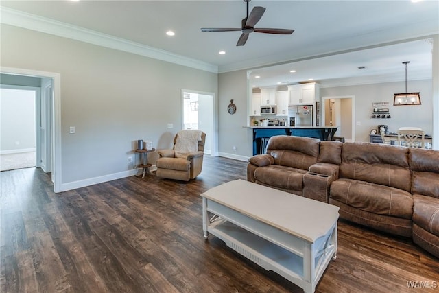 living room with ceiling fan, crown molding, and dark hardwood / wood-style floors