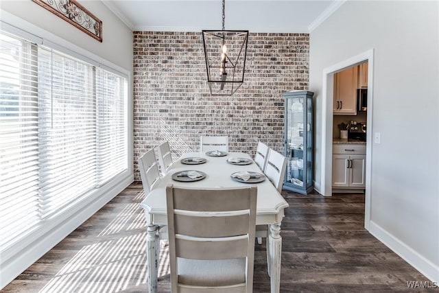 dining area with brick wall, a chandelier, and crown molding