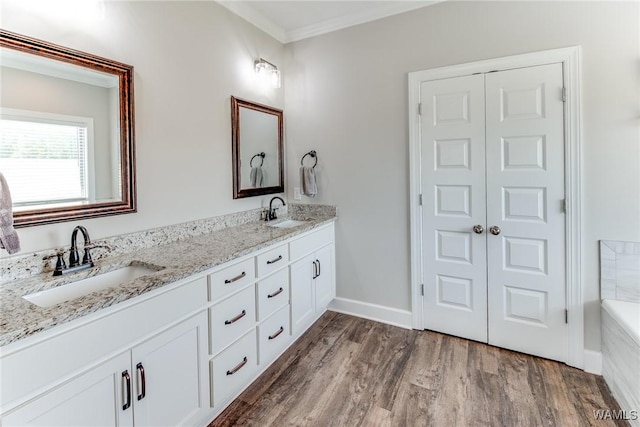 bathroom featuring vanity, hardwood / wood-style floors, and ornamental molding