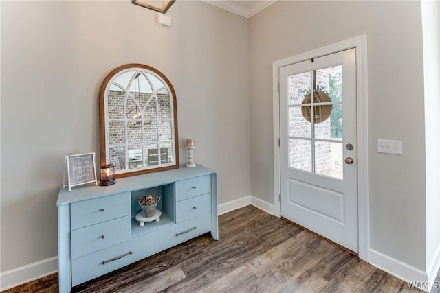 foyer featuring ornamental molding and dark wood-type flooring