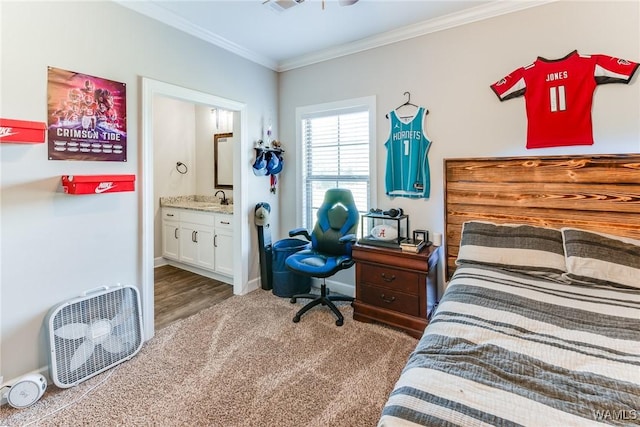 bedroom with sink, connected bathroom, ornamental molding, and dark colored carpet