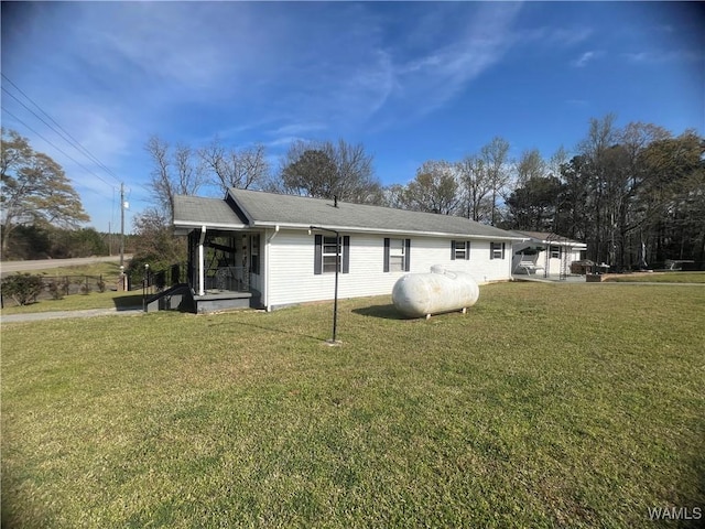 back of property featuring roof with shingles and a lawn