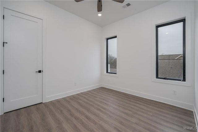 unfurnished room with ceiling fan and wood-type flooring