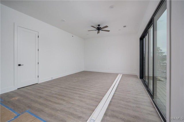 spare room featuring ceiling fan and light hardwood / wood-style floors