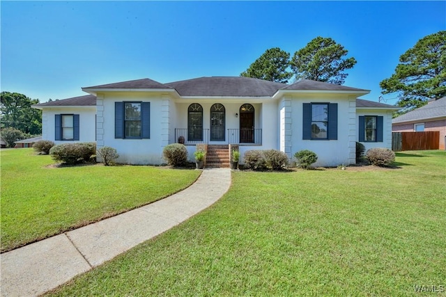 single story home featuring a porch and a front yard