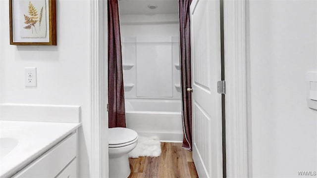 full bathroom featuring shower / bathtub combination with curtain, hardwood / wood-style floors, vanity, and toilet