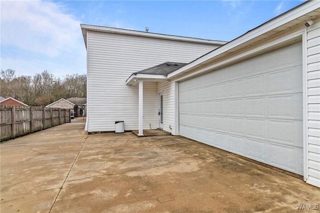 rear view of property featuring a garage