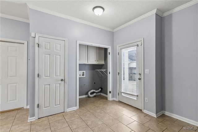 washroom featuring cabinets, ornamental molding, hookup for a washing machine, and light tile patterned floors