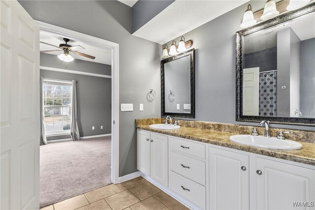 bathroom featuring ceiling fan, vanity, and tile patterned flooring