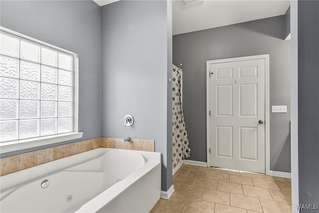 bathroom featuring tile patterned flooring and plus walk in shower