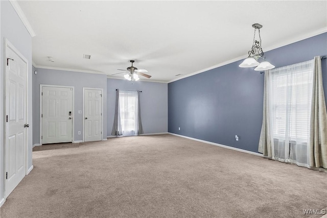 spare room with crown molding, light colored carpet, and ceiling fan