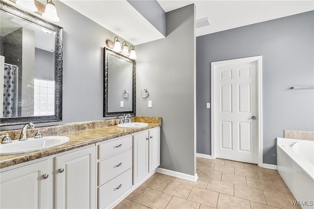 bathroom with vanity, tile patterned floors, and a tub to relax in