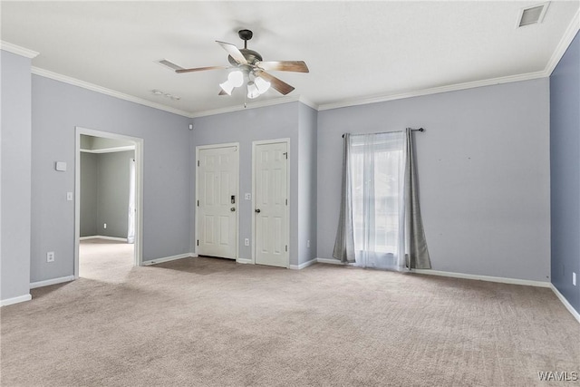 unfurnished bedroom featuring multiple closets, crown molding, light colored carpet, and ceiling fan