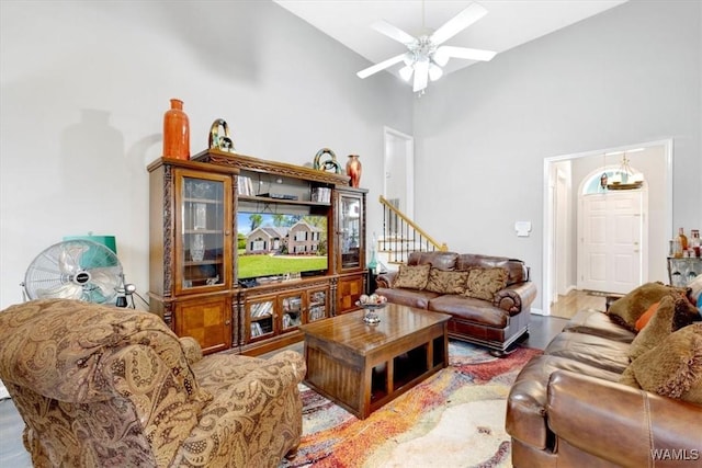 living room featuring ceiling fan and high vaulted ceiling