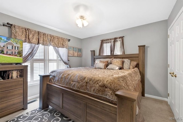 carpeted bedroom with a closet