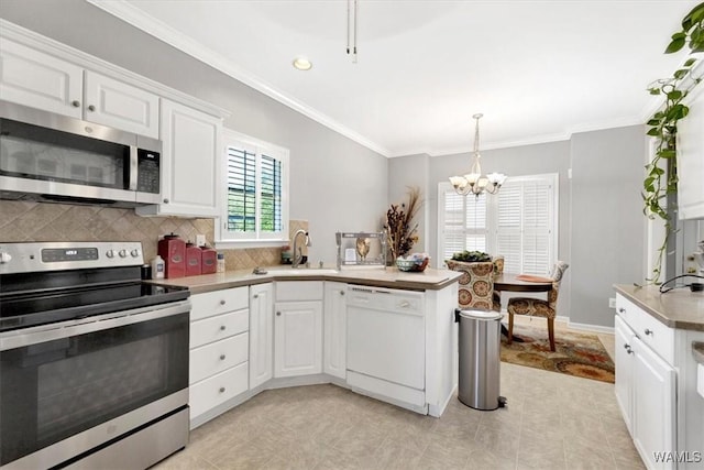 kitchen featuring white cabinets, decorative light fixtures, stainless steel appliances, tasteful backsplash, and crown molding