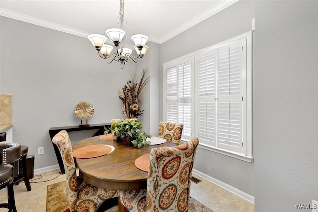 dining space with ornamental molding and a chandelier