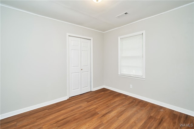 unfurnished room with hardwood / wood-style floors and ornamental molding