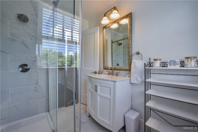 bathroom featuring a shower with door and vanity