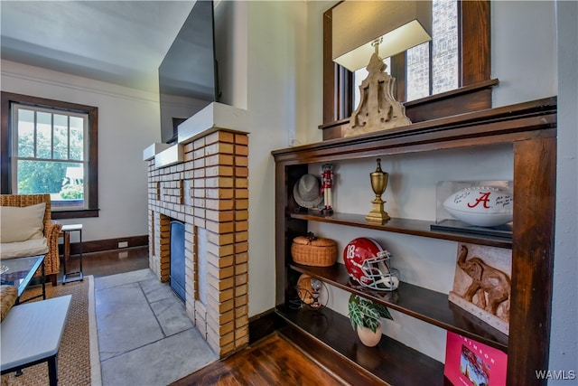 interior space featuring hardwood / wood-style flooring and a brick fireplace