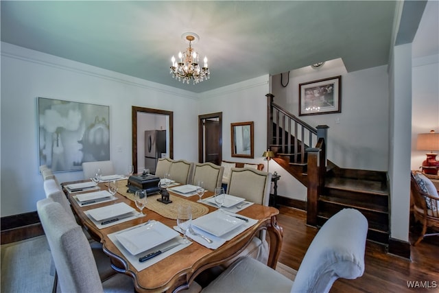 dining area with ornamental molding, dark wood-type flooring, and a chandelier