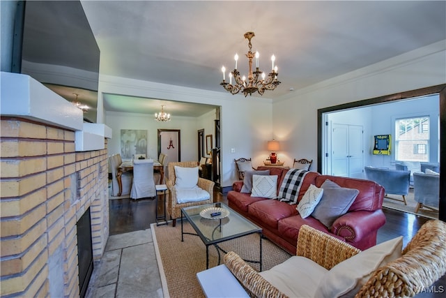 living room with crown molding, a fireplace, a chandelier, and hardwood / wood-style flooring