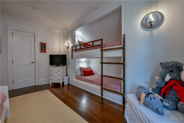 bedroom featuring ceiling fan, dark hardwood / wood-style flooring, and crown molding