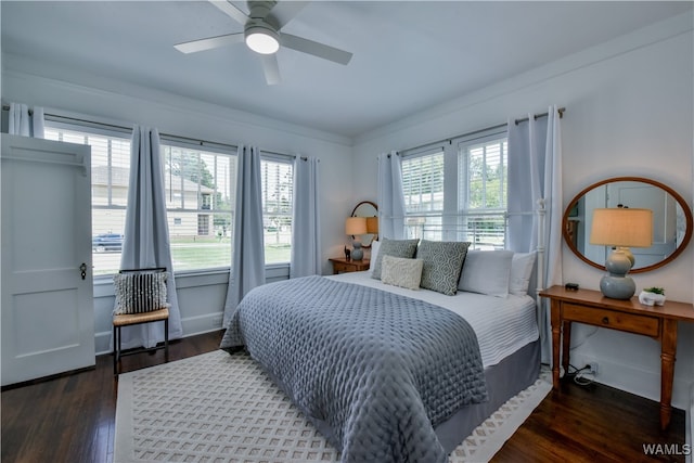 bedroom featuring ceiling fan, crown molding, and dark wood-type flooring