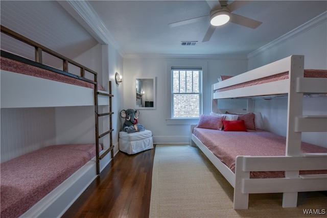 bedroom with crown molding, ceiling fan, and dark wood-type flooring