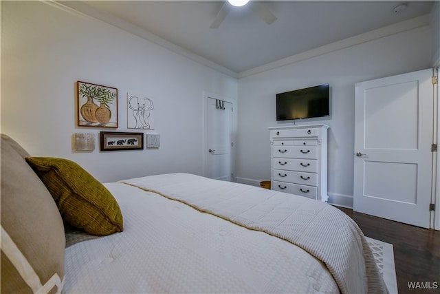 bedroom with dark hardwood / wood-style floors, ceiling fan, and ornamental molding