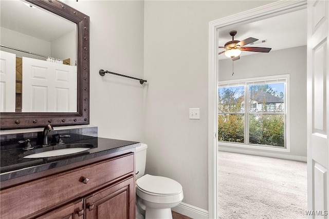 bathroom with ceiling fan, vanity, and toilet