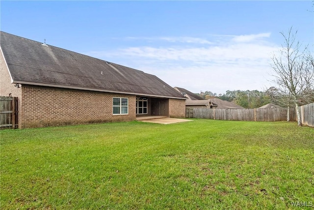 rear view of property with a patio area and a yard