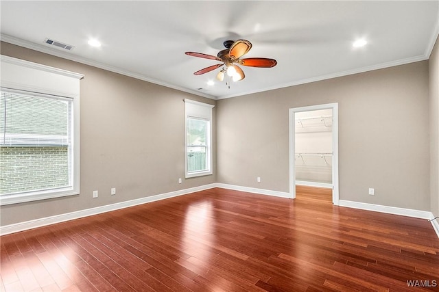 spare room featuring hardwood / wood-style floors, ceiling fan, and ornamental molding