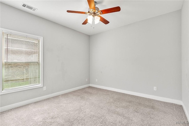 carpeted spare room featuring ceiling fan