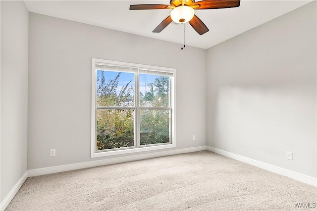 carpeted empty room featuring ceiling fan