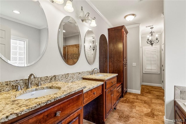 bathroom with vanity, ornamental molding, and an inviting chandelier