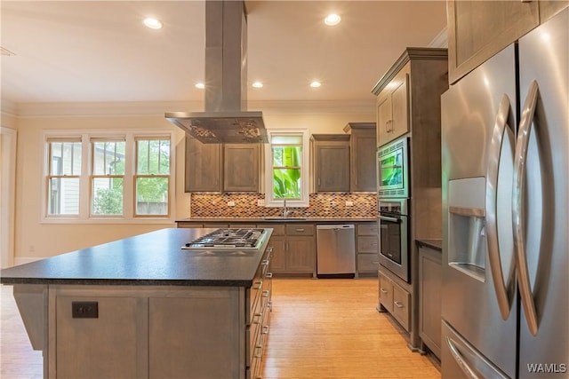 890 Founders St, Tuscaloosa, AL 35406 - kitchen featuring stainless steel appliances, dark countertops, island range hood, crown molding, and light wood-style flooring