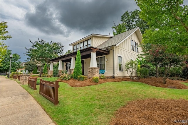 890 Founders St, Tuscaloosa, AL 35406 - view of front facade featuring a metal roof, a front lawn, board and batten siding, and a standing seam roof