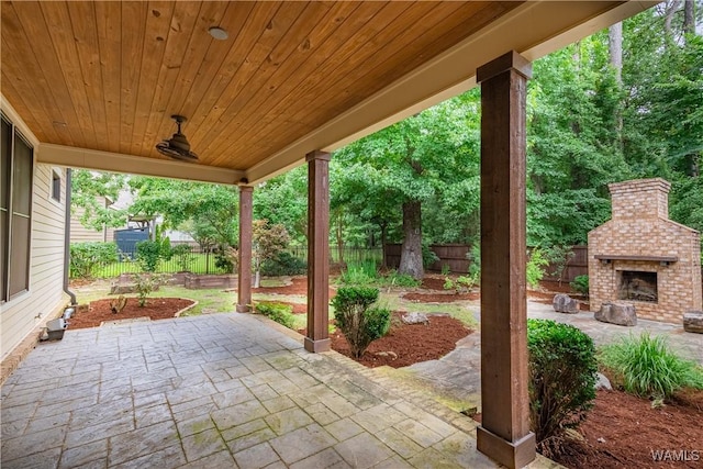 890 Founders St, Tuscaloosa, AL 35406 - fenced backyard with an outdoor brick fireplace and a patio area