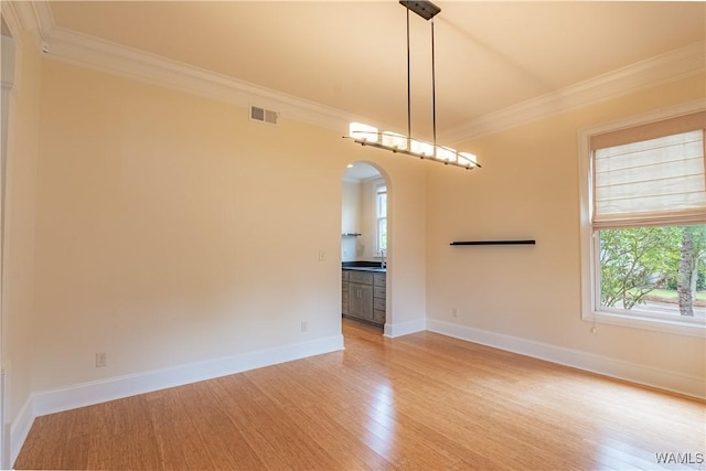 890 Founders St, Tuscaloosa, AL 35406 - empty room featuring crown molding, arched walkways, and light wood-style flooring